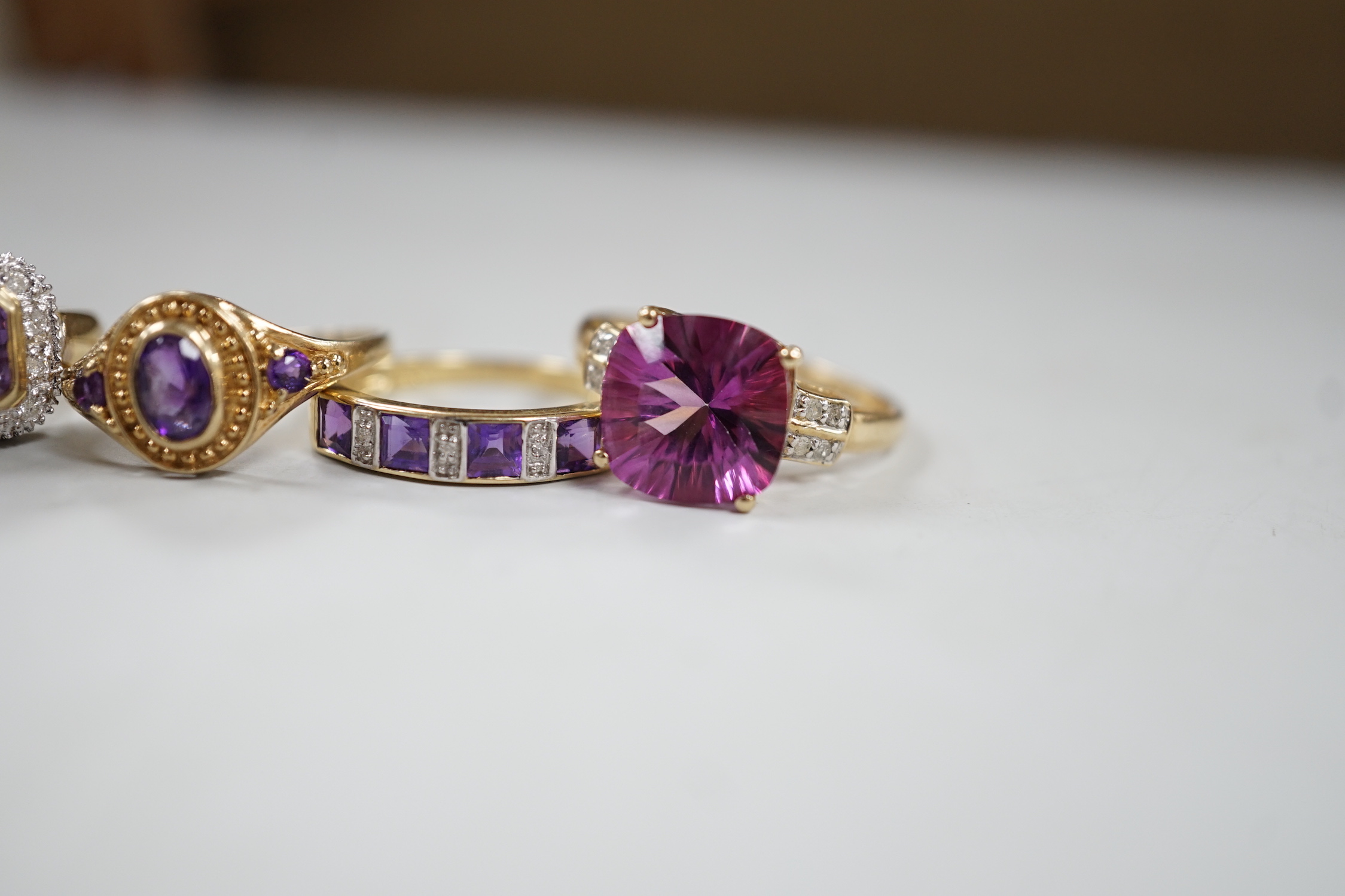 Five assorted modern 9ct gold and gem set dress rings, including diamond chip half hoop and amethyst and diamond chip half hoop, gross weight 12.6 grams.